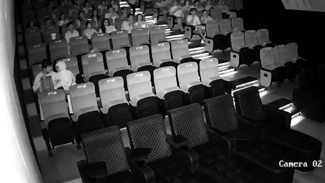 A couple having sex in front of everyone in a cinema hall