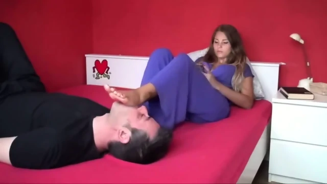 Stunning Girl Rests Her Glamour Sexy Feet On A Handsome Dudes Face