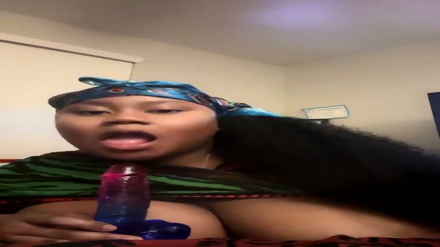Ebony Big Tits sucking Dildo