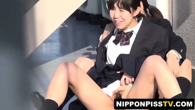 Lens closes as Japanese students pee in the open public