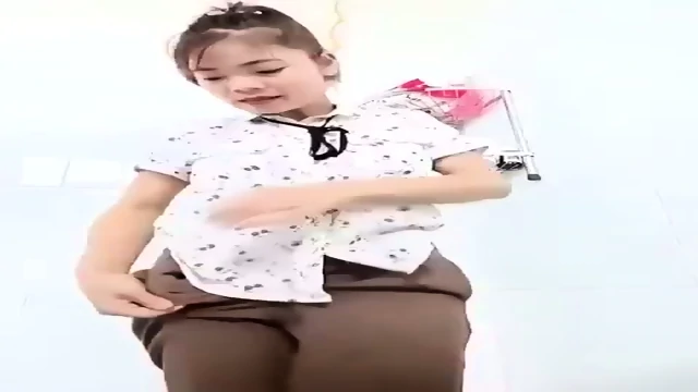 Vietnamese slut playing with vibrator in her pants in public
