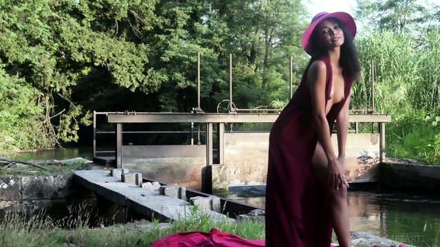 A Real Bombshell Poses For The Camera Outside In A Stream