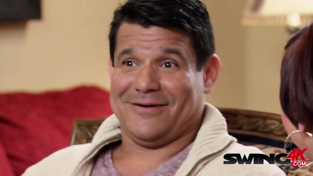 Kissing contest between swapped swinger couples at a BBQ party.