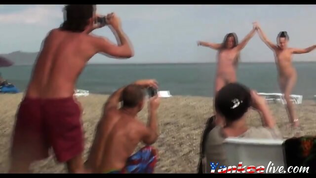 Voyeur on public beach. Girls posing
