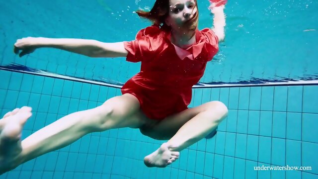 Cute babe in red sexy open dress swimming
